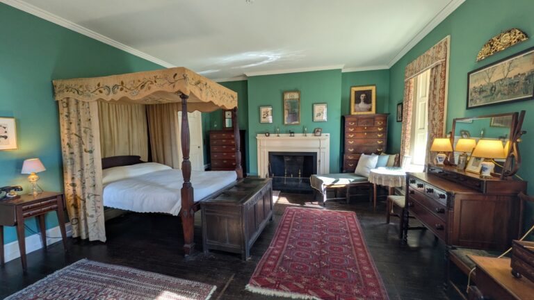 Bedroom in the Nichols House Museum with bed hangings embroidered by Rose Nichols. Nichols House Museum