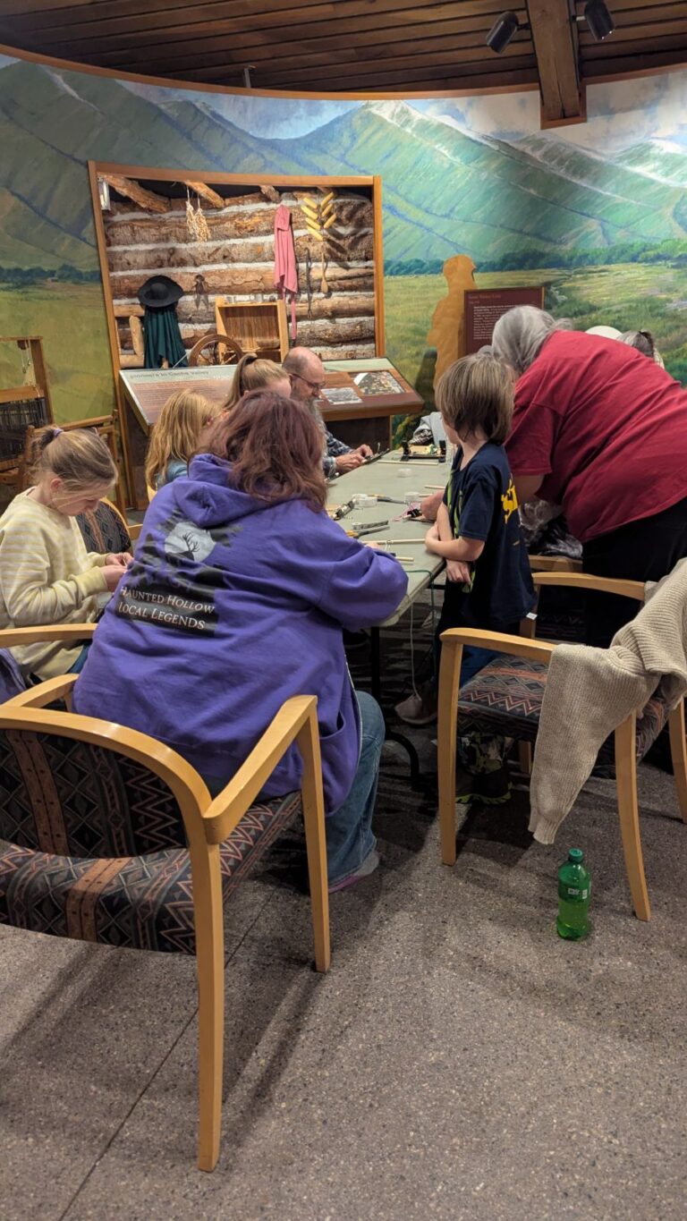 A group of students working on finger weaving. Annalise Christensen