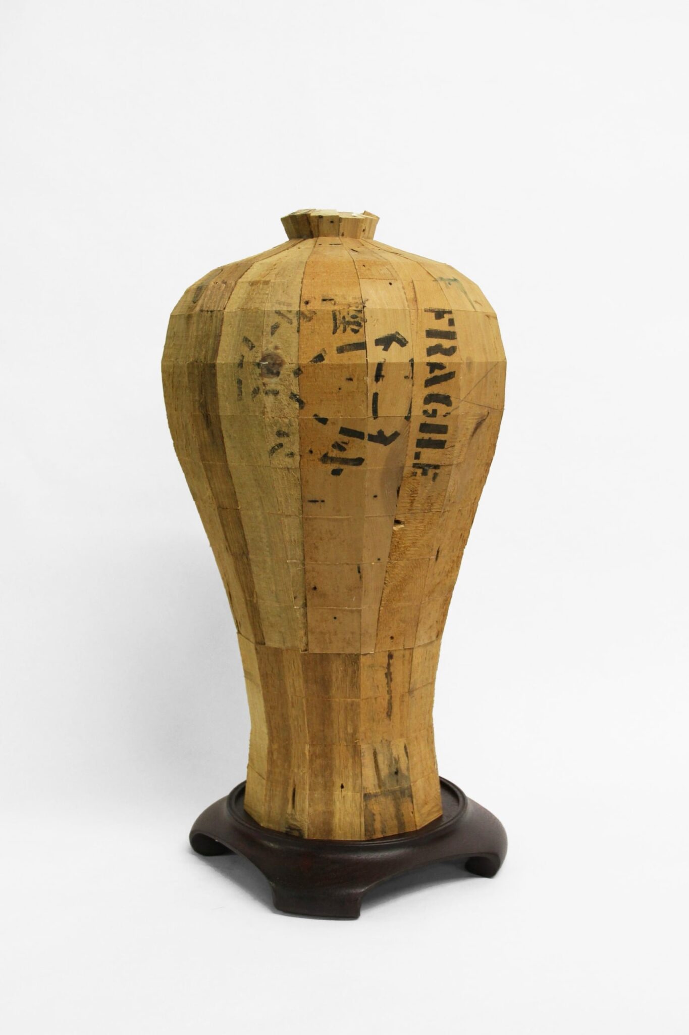 Vivan Chiu, Meiping Vase II, 2023, pine crate wood from W.O.W, rosewood stand, 20” x 11.5” x 11.5,” School of Art and Design, University of Arkansas at Little Rock, Little Rock, Arkansas.