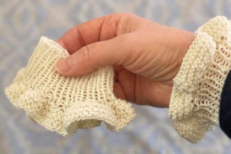 Hand holding a lace cuff Hand holding a lace cuff. American Swedish Institute