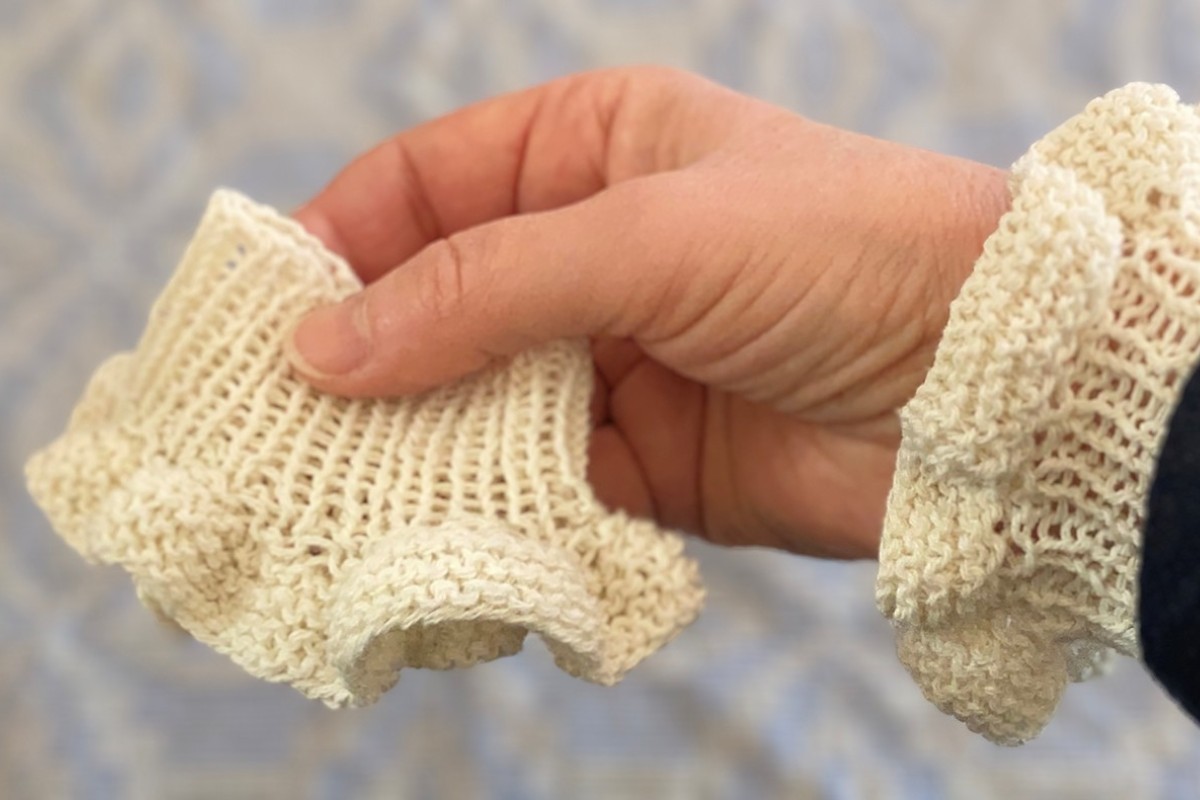 Hand holding a lace cuff. American Swedish Institute