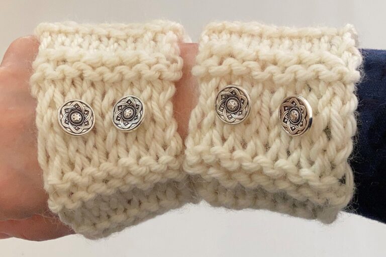 Close-up of knitted wrist warmers with decorative buttons Close-up of knitted wrist warmers with decorative buttons. American Swedish Institute