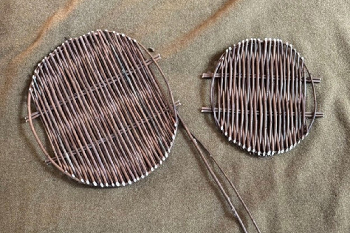 Two woven willow strainers rest on a textured surface. American Swedish Institute