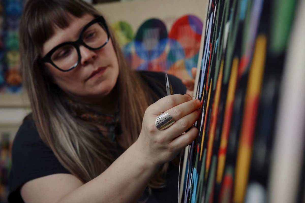 Tia Keobounpheng working on an art piece. American Swedish Institute