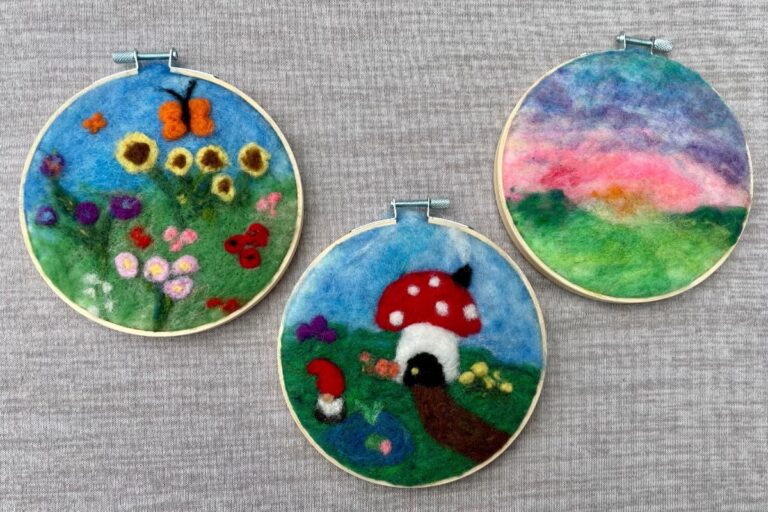 Three felt spring scenes in min grapevine wreaths. American Swedish Institute