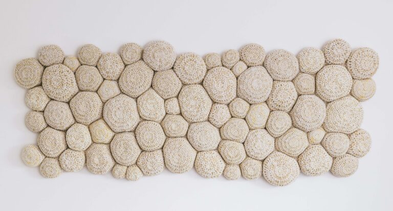 Holly Guertin, The Intimacy, 2024, crocheted and stitched wool and fill, reclaimed domestic fabric, 65"w x 28"h x 3"d. Artwork by Holly Guertin, Photo by Erin Ingraffia Photography