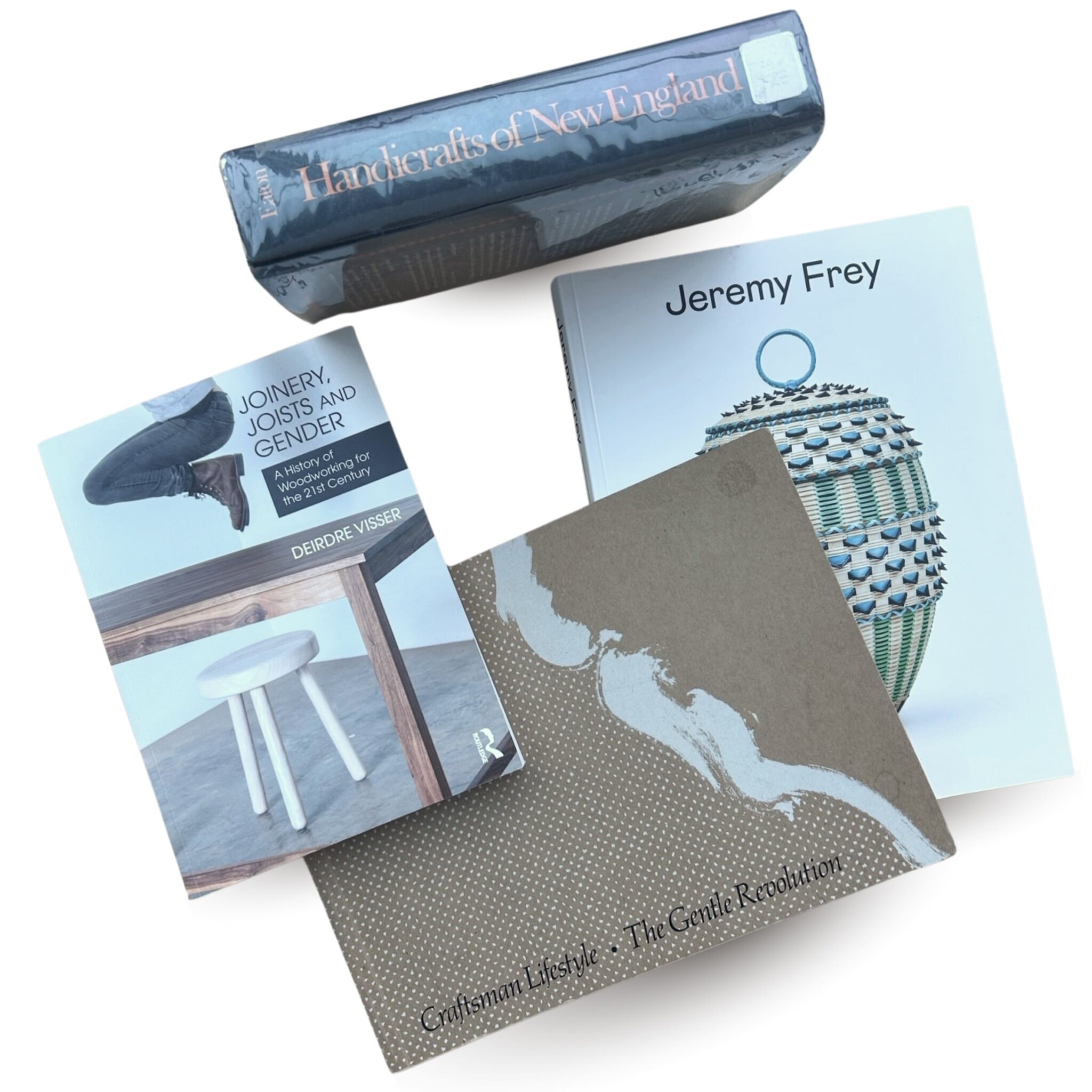 A selection of craft focused texts including "Joinery, Joists, and Gender" by Deirdre Visser; "Handicrafts of New England" by Allen H. Eaton; "Jeremy Frey: Woven" by Andrew James Hamilton, Dakota Hoska, and Jaime DeSimone; "Craftsman Lifestyle: The Gentle Revolution" by Olivia H. Emery. Courtesy of Instructor Dr. Michelle Millar Fisher