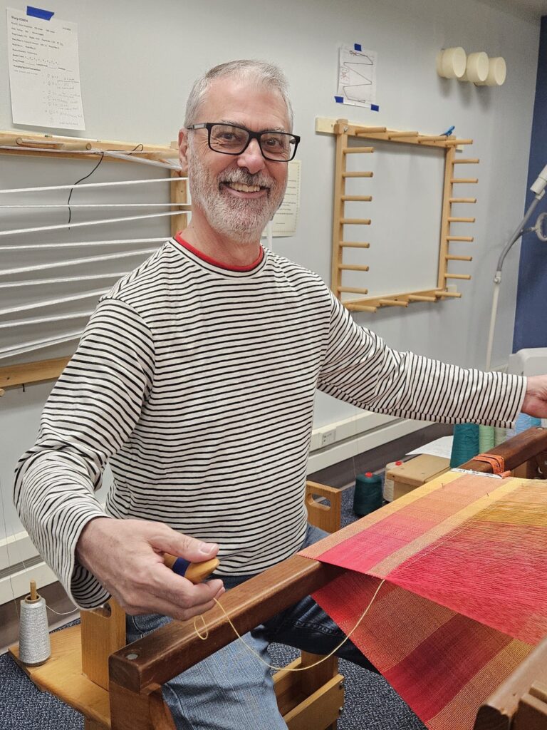 Artisan Rui is weaving on our community loom in the Main studio. Hartford Artisans Weaving Center