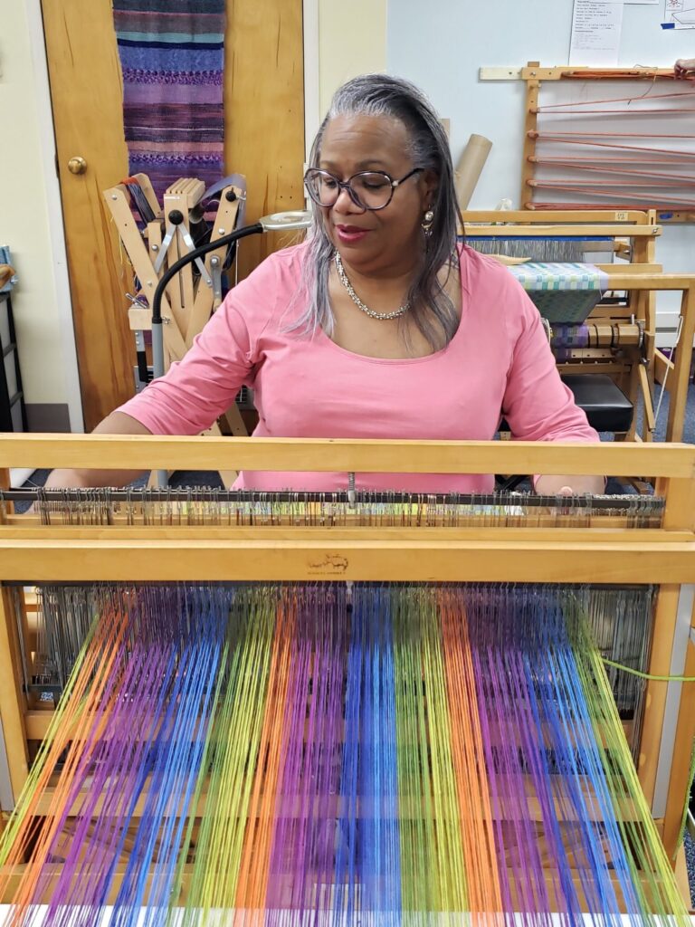 Artisan Valerie is weaving at her loom in our Main studio. Hartford Artisans Weaving Center