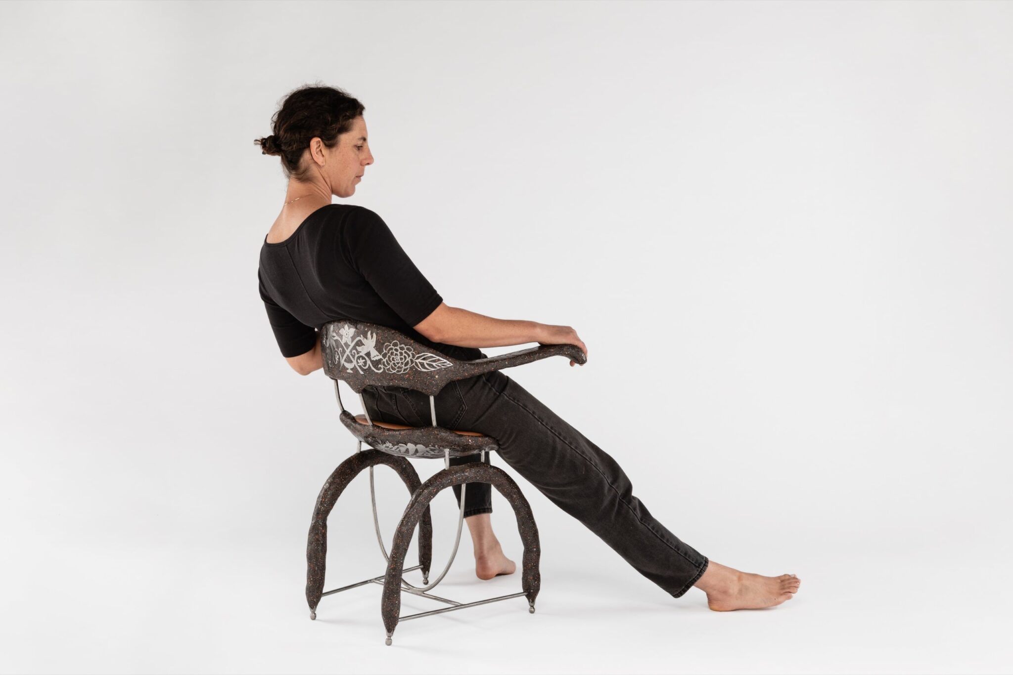 Elsa Hoffman in “omen armchair,” a 2024 sculptural piece made from steel, concrete and leather standing at 19"x29"x28.75". ALEX MANESS