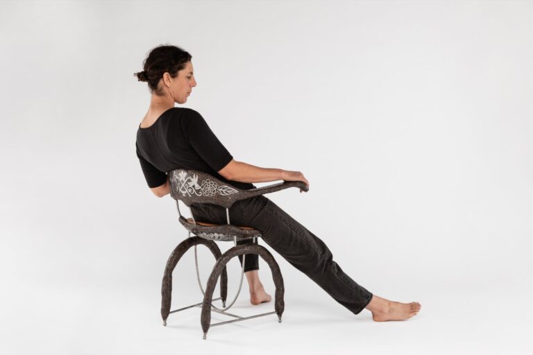 Elsa Hoffman in “omen armchair,” a 2024 sculptural piece made from steel, concrete and leather standing at 19"x29"x28.75". ALEX MANESS