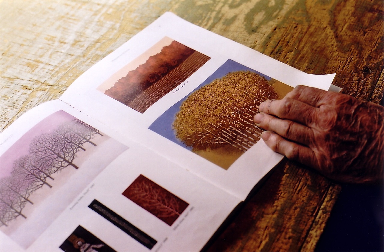 Charles Beck and a book of his prints.