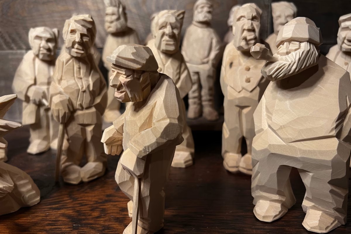 Collection of carved wooden figures of people. American Swedish Institute