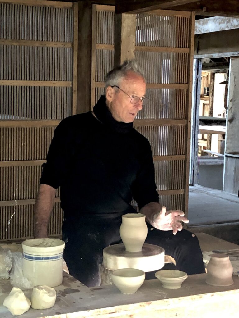 While throwing on one of the historic wheels at a Pond Farm Pottery tour in 2024, Hunt Prothro shares insights from his many summers spent studying with celebrated ceramicist Marguerite Wildenhain. Photo credit Laurie Prothro