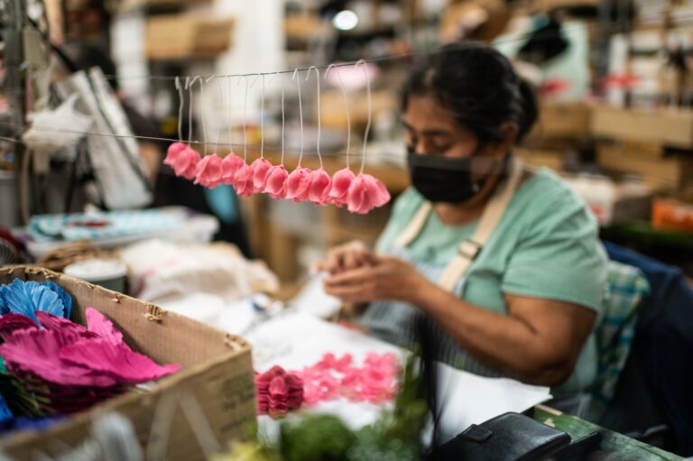 A skilled artisan assembles a handcrafted fabric flower at M&S Schmalberg’s New York City studio. M&S Schmalberg