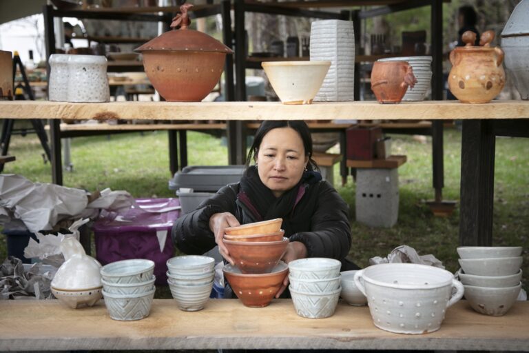 Customer Looking at Host Peter Jadoonath's pottery. Ariana Lindquist