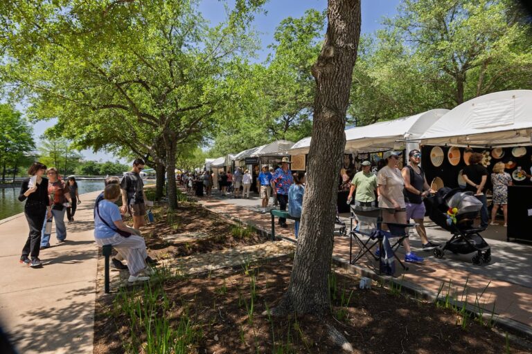 Festivalgoers explore artist booths along The Woodlands Waterway®, enjoying scenic views while discovering original works across a variety of mediums. Mauricio Ramirez