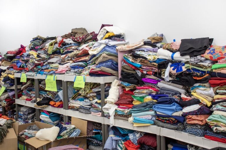 Shelves stocked high with fabric at the Textile Garage Sale. Textile Center