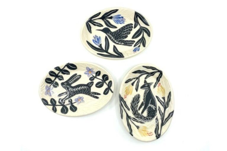 Three small ceramic dishes featuring various wildlife. American Swedish Institute