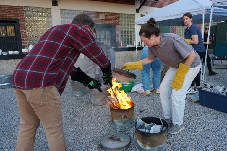 Participants adding pots to combustible chamber Participants adding pots to combustible chamber. Belger Arts