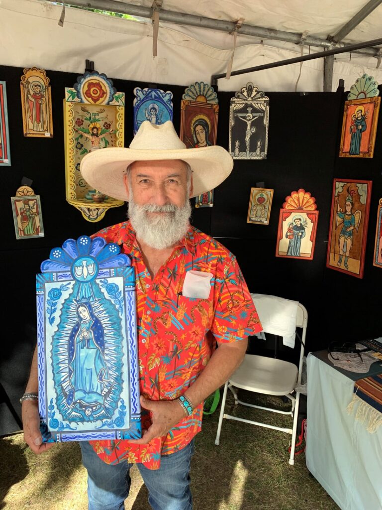 Charles M. Carrillo in his booth at Traditional Spanish Market, Santa Fe, NM, July 2025. Courtesy Maryhill Museum of Art
