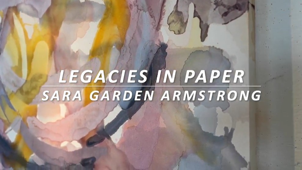 Legacies in Paper: Sara Garden Armstrong, in white text over a large painting of swirls of purple and yellow pigment on paper. Image courtesy of Sara Garden Armstrong