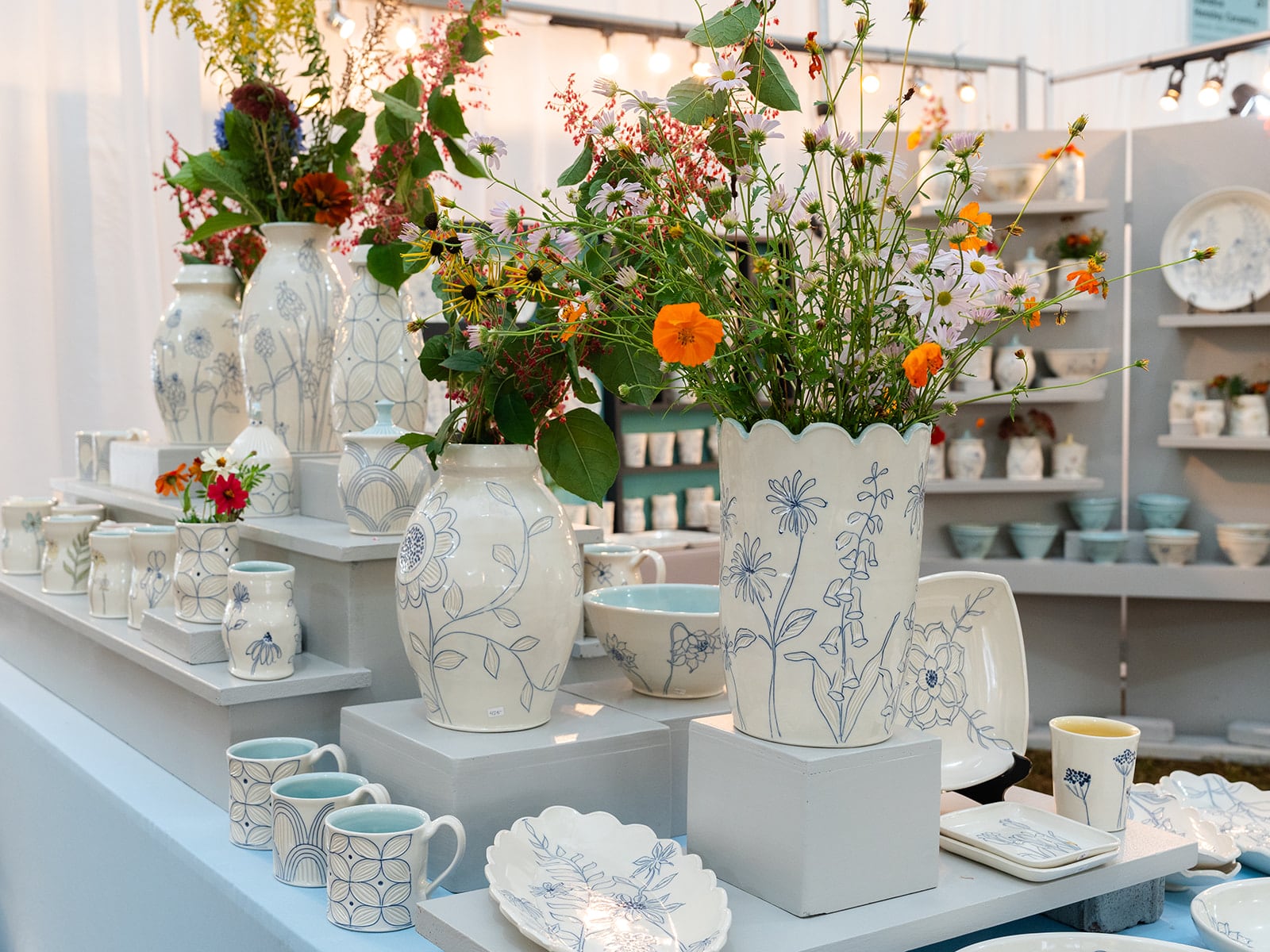 Ceramic works by North Carolina artist Julie Wiggins on view under the tent during Potters Market at the Mint at Mint Museum Randolph. Photo by Adam Eugene Photo