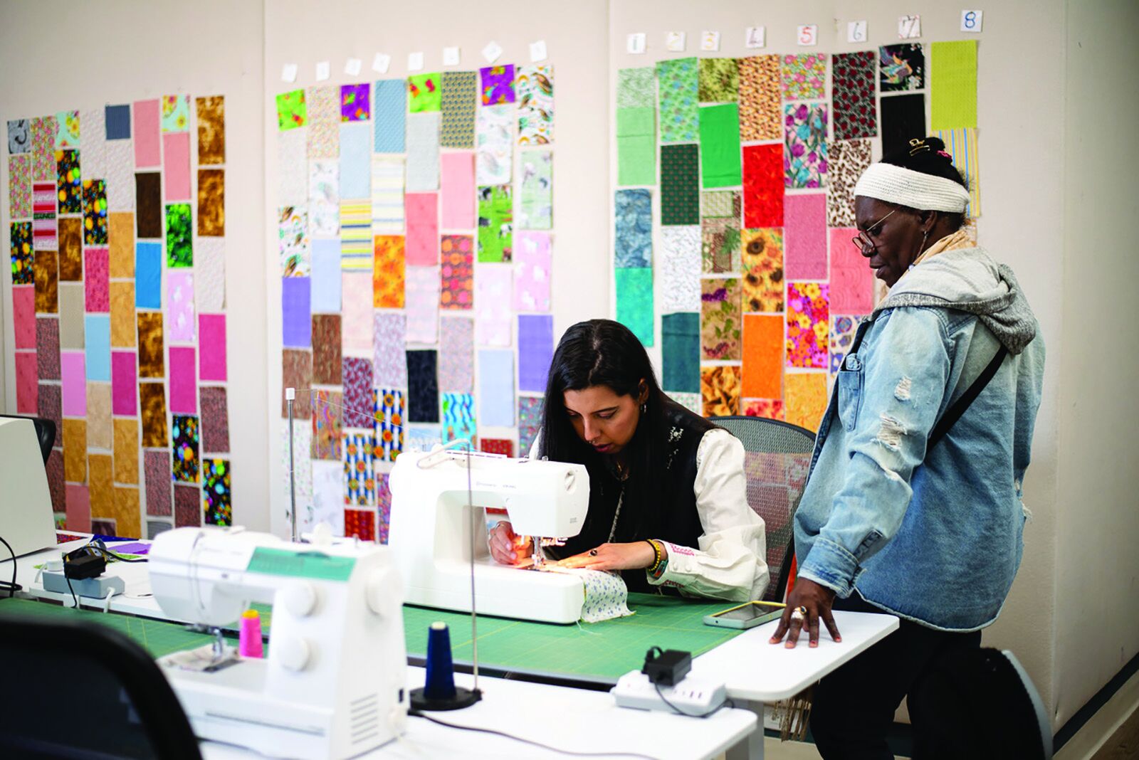 Jacinta guiding a new student on joining her first seams at Quilting for Community in Chatsworth. (Jordan Fong/Submitted)