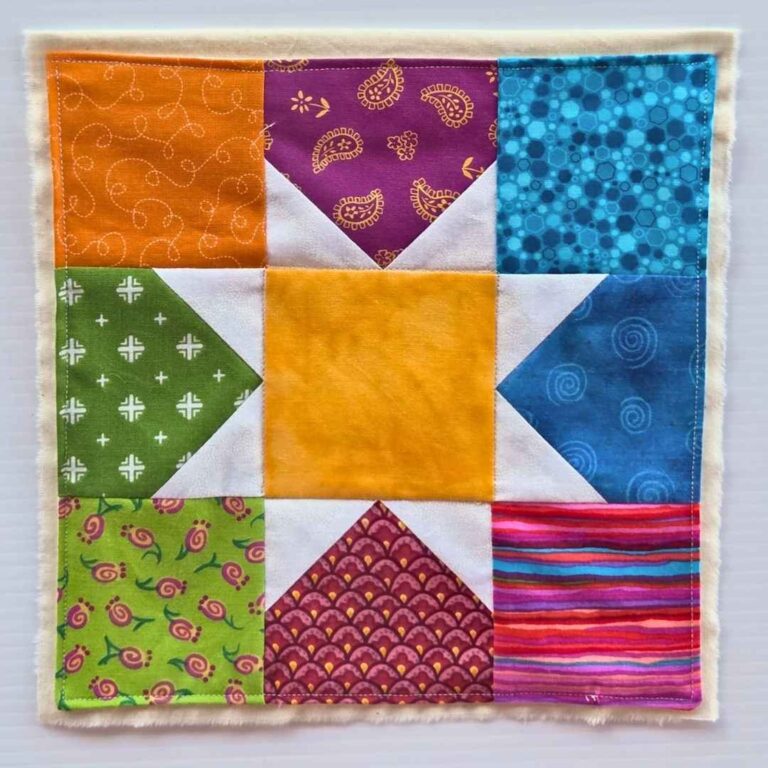 Flag made by the Mill to Mill Textile Fellowship. Pieced patchwork square in quilting cotton on muslin. image courtesy of the Red Mill Museum Village