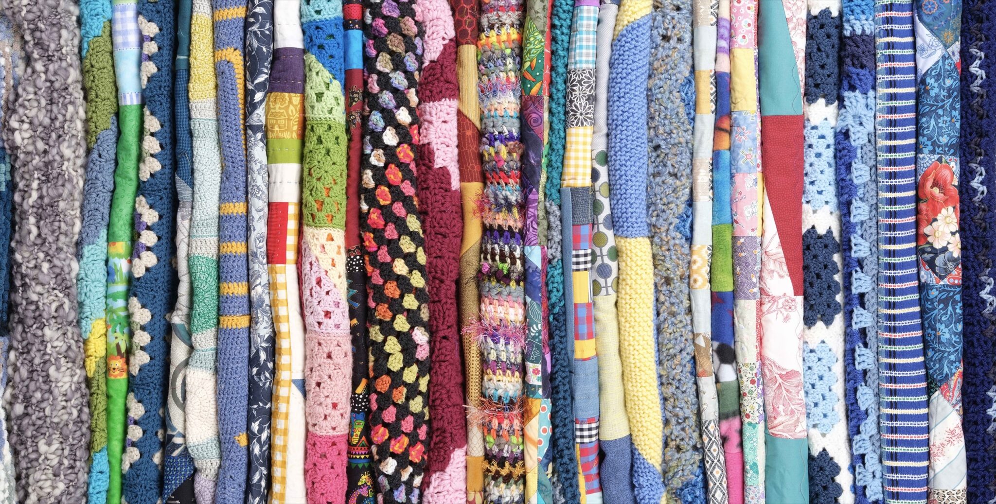 Welcome Blanket’s welcome mural at Los Angeles International Airport Terminal 4 translates the project’s handmade collection into a large-scale public artwork travelers pass every day Welcome Blanket's welcome mural at Los Angeles International Airport Terminal 4 translates the project's handmade collection into a large-scale public artwork travelers pass every day. Image by Jayna Zweiman