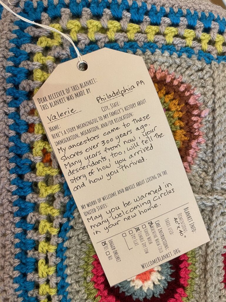 A welcome note from maker Valerie of Philadelphia, PA, one of thousands of family migration stories stitched into the Welcome Blanket archive A welcome note from maker Valerie of Philadelphia, PA, one of thousands of family migration stories stitched into the Welcome Blanket archive. Image by Jayna Zweiman