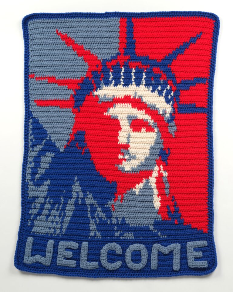 A hand-crocheted blanket by Welcome Blanket participant Sonia Savoulian reimagines the Statue of Liberty in red, white, and blue, one of over 8,000 blankets made for Welcome Blanket since 2017. Welcome blanket by Sonia Savoulian A hand-crocheted blanket by Welcome Blanket participant Sonia Savoulian reimagines the Statue of Liberty in red, white, and blue, one of over 8,000 blankets made for Welcome Blanket since 2017. Welcome blanket by Sonia Savoulian. Photo by Jayna Zweiman.