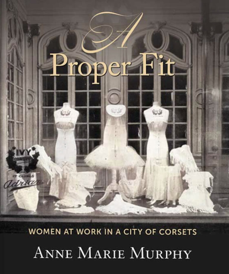 Dress forms with corsets on them sitting on a table in a large elegant room Dress forms with corsets on them sitting on a table in a large elegant room