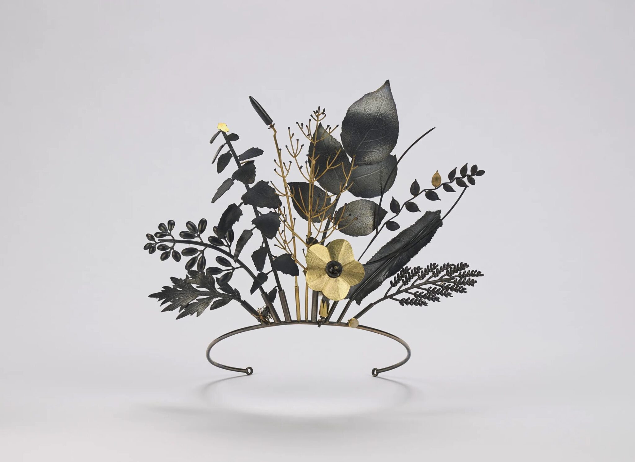 Jan Yager, Tiara of Useful Knowledge, from the series City Flora: The Philadelphia Series, 2006, 18- and 14-karat gold, oxidized sterling silver, and quartz pebble, Smithsonian American Art Museum, Gift of Linda L. Brownrigg, Cynthia Lovelace Sears, and Todd Wingate and Steven Cason in honor of Handwork: Celebrating American Craft 2026, 2025.8A-M, © 2006, Jan Yager