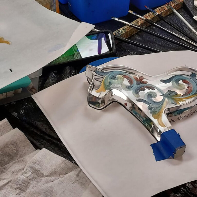 Rosemaling a Dala Horse. Vesterheim