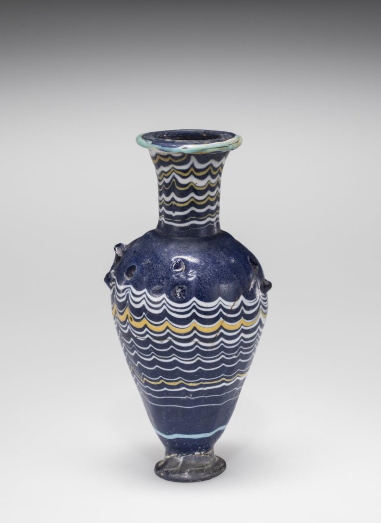 Amphoriskos (Cosmetic bottle). Made in Egypt, probably sometime between 1400 BCE and 1300 BCE. Core-formed glass, trail decorated and hot worked. 50.1.1. Image courtesy of the Corning Museum of Glass.