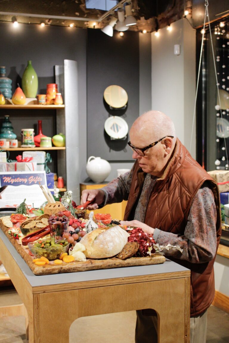 Visitor enjoying hors d'oeuvres in the gallery. Northern Clay Center